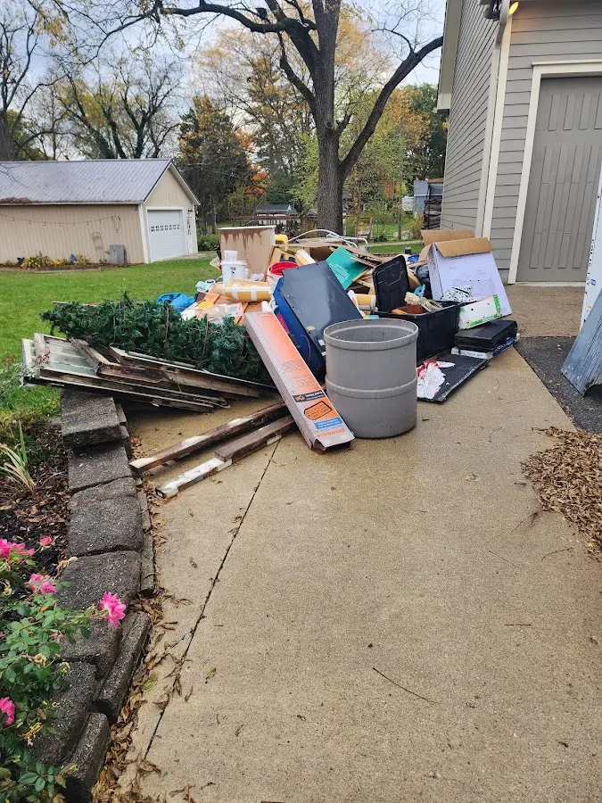 Dumpster being loaded with debris for Residential Dumpster Rental in Chisholm
